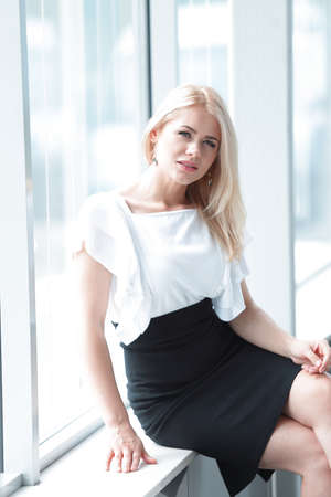 modern business woman sitting near the window in the office.の写真素材