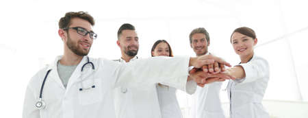 Doctors and nurses in a medical team stacking handsの写真素材