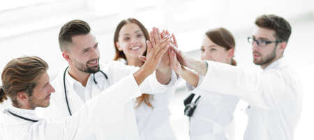 group of doctors giving each other a high five.の写真素材