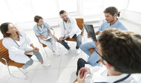 doctors discuss an x-ray ,sitting in the office.の写真素材