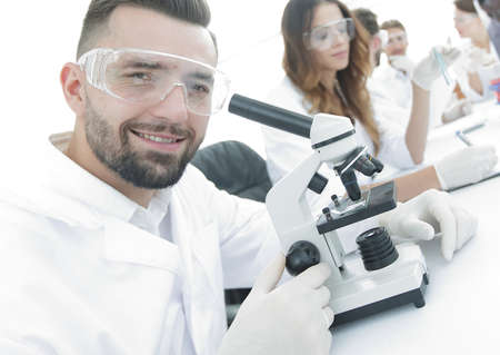 closeup of male technician sitting at his working in the laboratoryの写真素材