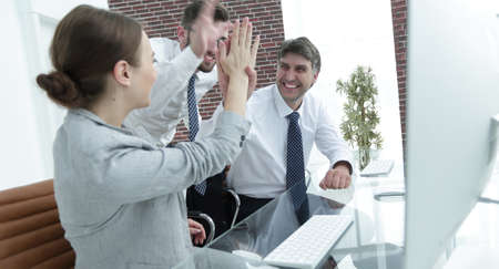 business team "makes five" as a sign of successの写真素材