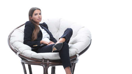 young business woman relaxes in a round chairの写真素材
