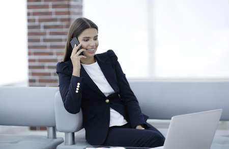 female Manager talking on mobile phoneの写真素材