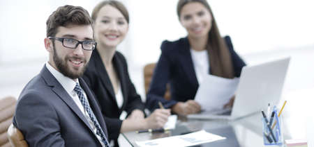 employees sitting behind a Desk.