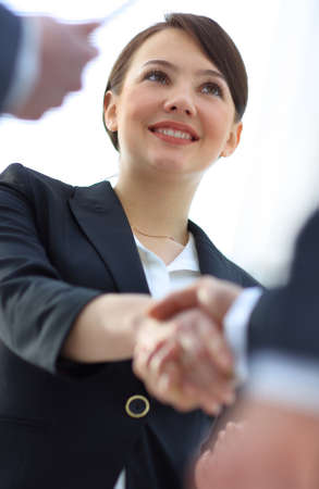 closeup of business woman shaking hands with her business partner.の写真素材