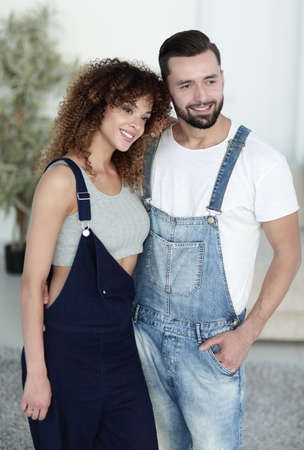 beautiful young couple standing in a new apartment. Photo has a copy of spaceの写真素材