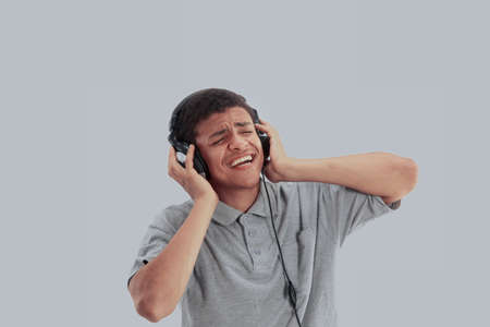 Young happy man listening to music and singingの写真素材