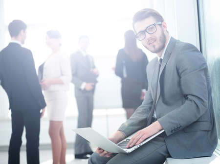 closeup of a businessman with a stylish laptop on the knees on tの写真素材