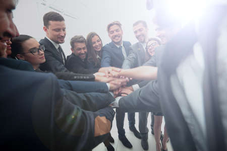 Large business team showing unity with their hands togetherの写真素材