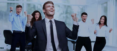 victory in business. jubilant businessman and  team on o