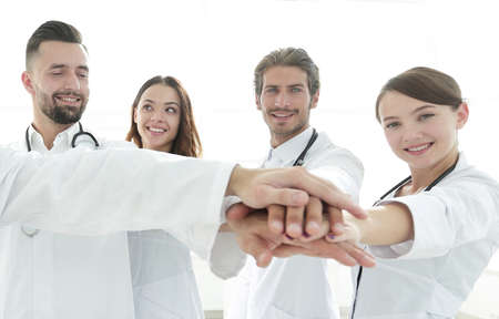 Doctors and nurses in a medical team stacking handsの写真素材