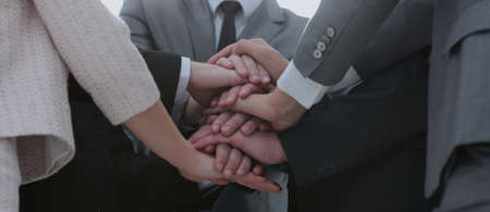 Business people join hand together during their meeting