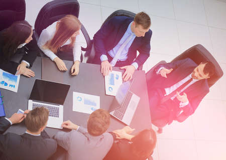 Business People Having Board Meeting In Modern Office