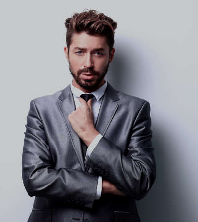 Close up portrait of a smiling handsome business man  over whiteの写真素材