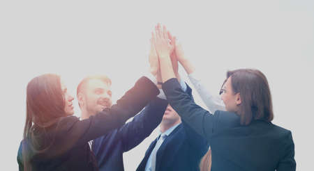 Group of business people celebrating their teamwork with a high five