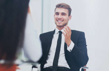 Young manager listening to his colleague explanationsの写真素材