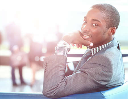 An African American business man with executives working in background