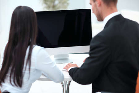 rear view.two successful employee sitting behind a Desk
