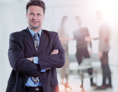Happy mature business man looking at camera with satisfaction at office