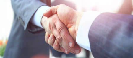 closeup of handshake of businessmen on blurred background .in the photo there is an empty space for your textの写真素材