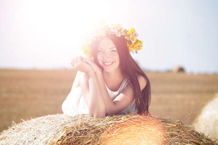 Happy woman in golden wheatの写真素材