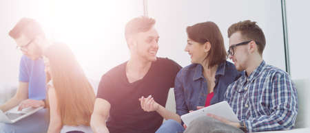 Group of young people in casual clothes chatting and having fun