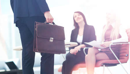 Close up portrait of a business man  with briefcase and collegueの写真素材