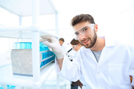 A young man doing an experiment in a chemical laboratory