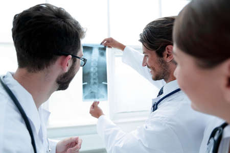Portrait of happy surgeons holding x-ray reportの写真素材