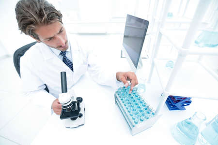 laboratory scientist working in a laboratory with a microscope