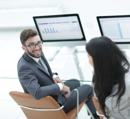 Colleagues discussing financial schedules in the workplace.の写真素材