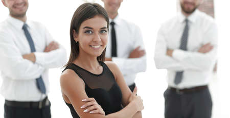 young employee of the company, standing in front of their colleagues.の写真素材