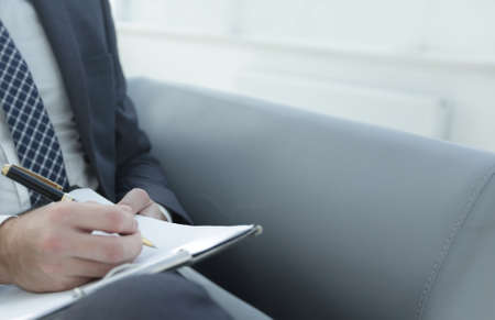 Businessman signs a contract. Holding pen in hand.の写真素材