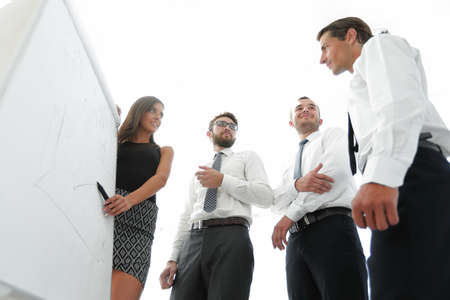 young business woman is colleagues their ideas on the flipchart.