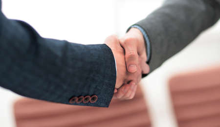 businessman shaking hands to seal a deal with his partner