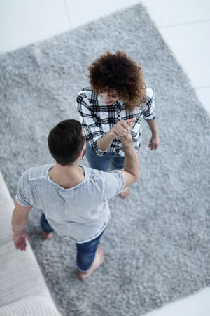 young couple give each other five in new living roomの写真素材