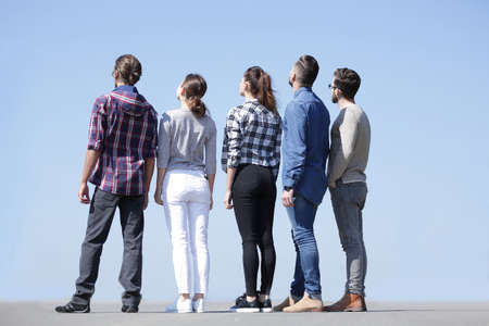 rear view.a group of young people looking at copy spaceの写真素材
