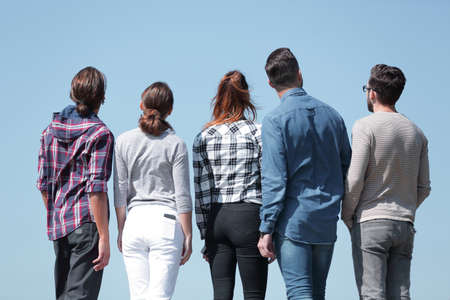 rear view.a group of young people looking at copy spaceの写真素材