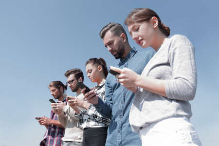 young people using smartphones to search network