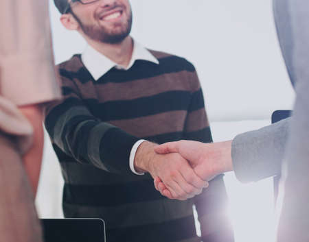 Business people closing a deal and handshaking at the officeの写真素材