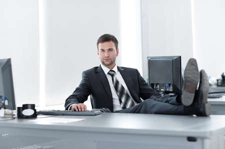 confident businessman sitting at Desk in a private officeの写真素材