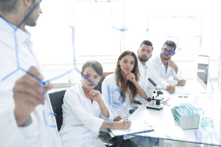 view through the transparent Board. a scientist makes a report.の写真素材