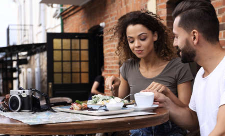 Portrait of lovely romantic couple sitting in a cafe with coffeeの写真素材
