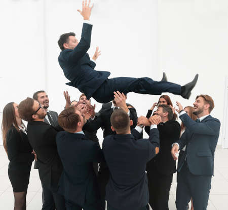 large business team rocking their leader.