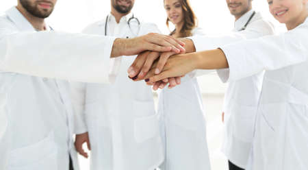 Doctors and nurses in a medical team stacking handsの写真素材