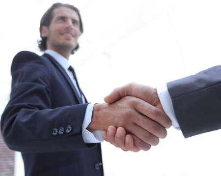 business group welcomes partner with a handshake