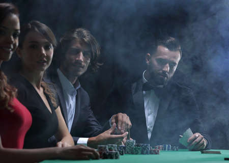 Men and woman talking at craps game in casinoの写真素材
