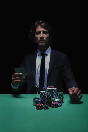 Young lucky gambler with cards and chips.の写真素材