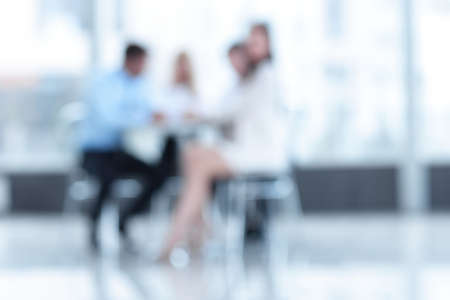 abstract blurred group of business people sitting at a tableの写真素材